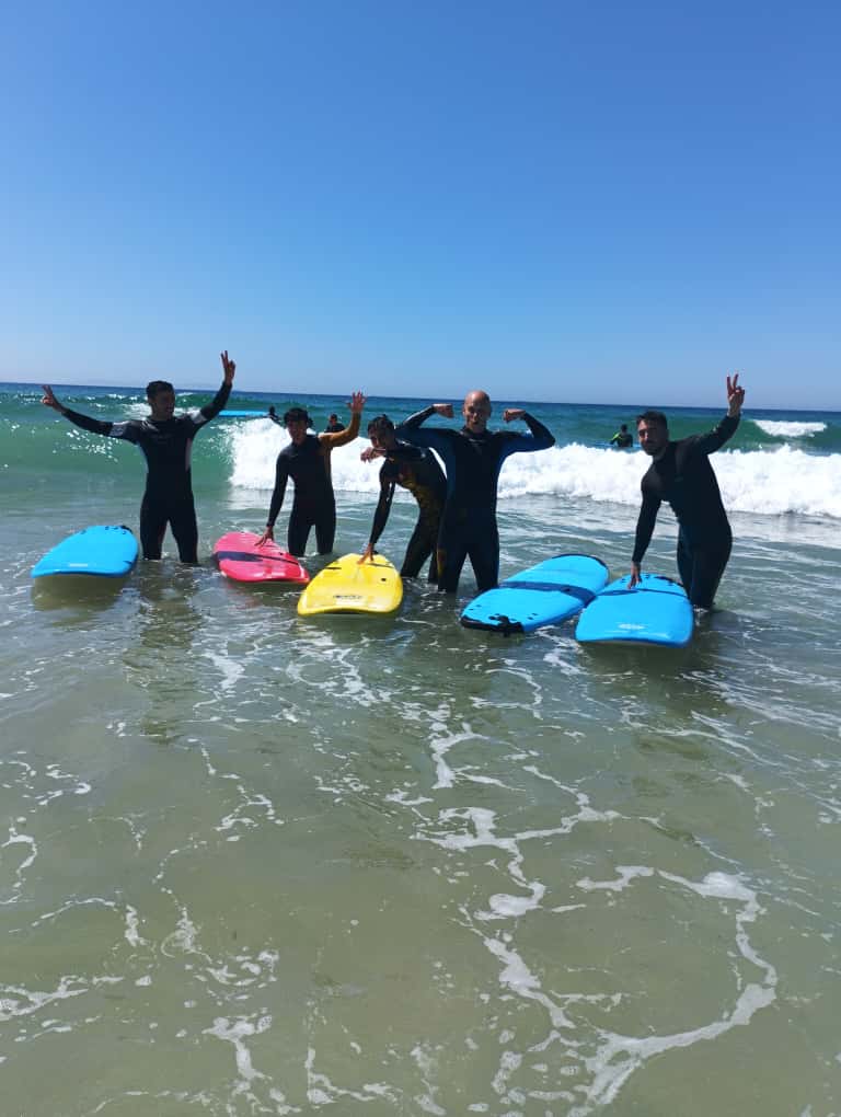 Friends enjoying best surfing in Tarifa in summer
